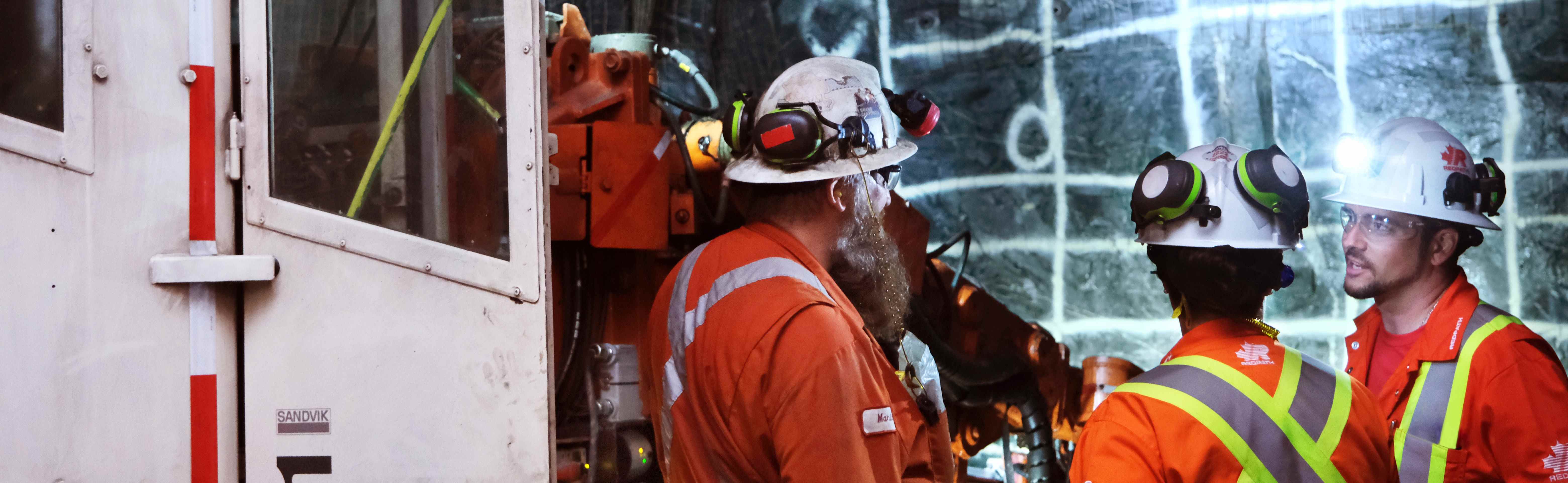 The website banner for the Supplier Portal page shows a group of Redpath employees, dressed in safety gear and surrounded by heavy duty machinery and equipment, having a conversation in an underground mine.